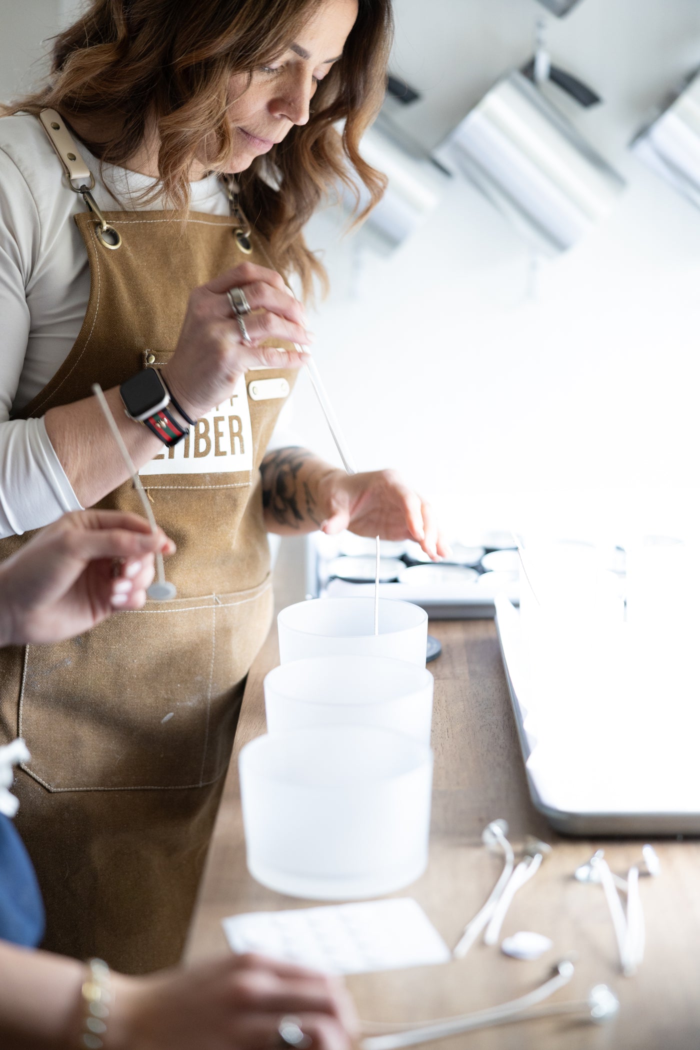 Amanda hand-pouring Salt + Ember soy candles in her New Jersey studio